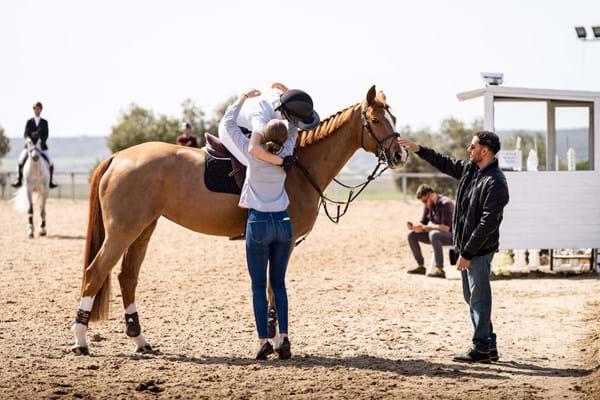 Competition-Rider-On-Horse-Celebrating-With-Hug