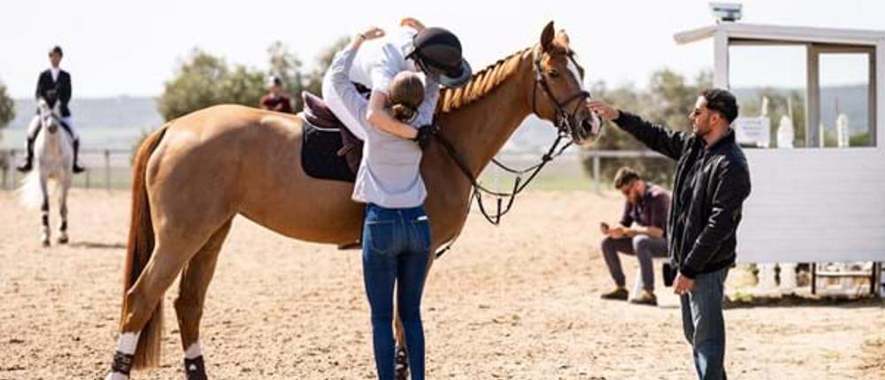 Competition-Rider-On-Horse-Celebrating-With-Hug